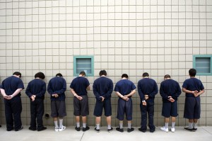 After class, wards wait for the ok from their deputy juvenile corrections officer's ok to continue to their unit for lunch at the Orange County Juvenile Hall in the City of Orange Tuesday morning. Wards walk with their hands behind their backs for safety. ////ADDITIONAL INFO: - 08_s.coedjuvi.0306.ks - Date Photographed: 3/6/12 - Time of day: 12:22:09 PM - Original File Name _KSB3581.NEF - KEN STEINHARDT, THE ORANGE COUNTY REGISTER -- Tuesday, March 6, 2012,